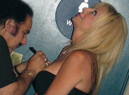 Shelley Lubben offers her breast to be signed by Ron Jeremy