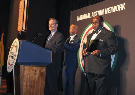AHF President Michael Weinstein accepts a "Keepers of the Dream" award from Rev. Al Sharpton (back left) and Rev. Dr. W. Franklyn Richardson, Nation Action Network Chairman (back right, holding award) at the 16th annual "Keepers of the Dream" awards gala in New York City on April 9, 2014 (Photo: Business Wire)
