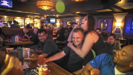 Nicki Hunter sings and hugs Scott May at Sardo's on Porn Star Karaoke night in Burbank. Brian van der Brug / Los Angeles Times