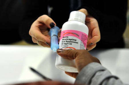 Bad News for AHF: A Milestone In The Campaign To Reduce The Number Of AIDS Deaths -- A mother gets antiretroviral drugs at the Chris Hani Baragwanath Hospital in South Africa in May 2012. Alexander Joe/AFP/Getty Images